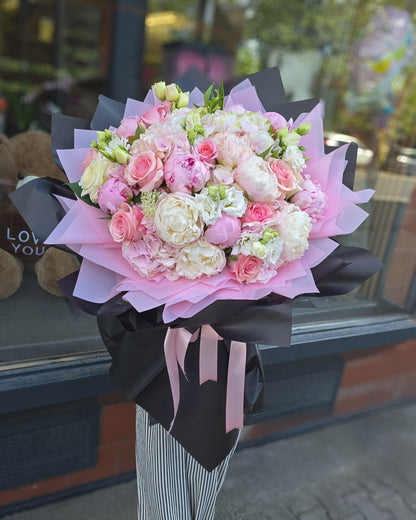Luxurious bouquet with peonies and roses in pink tones